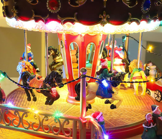 Carosello natalizio con animazioni e suoni giostra per villaggio di Natale h 28 cm