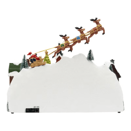 Paesaggio natalizio con Babbo Natale su slitta volante e pattinatori in movimento, led multicolor