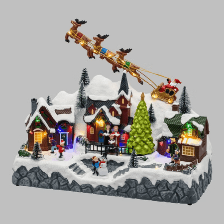 Paesaggio natalizio con Babbo Natale su slitta volante e pattinatori in movimento, led multicolor