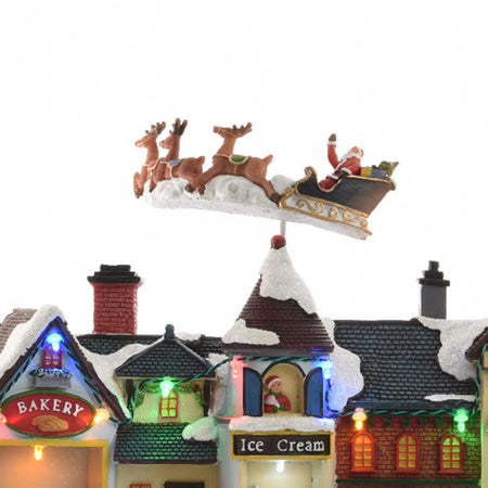 Scena animata a Led con negozi e babbo natale con renne con luci 27 cm