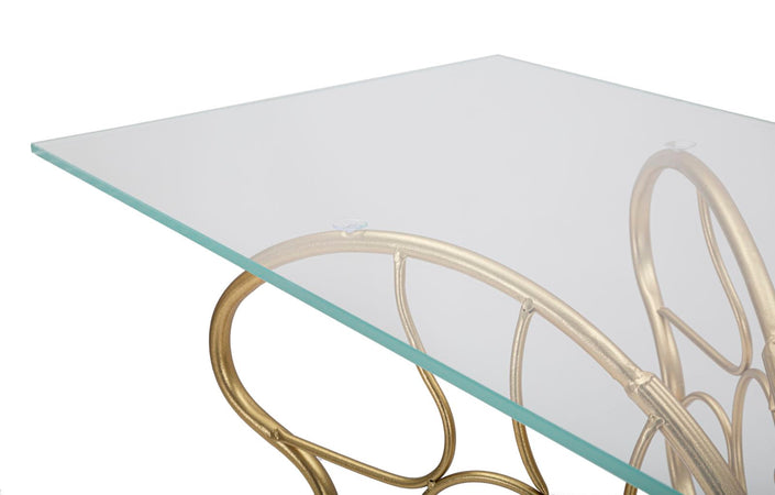 Console struttura forma farfalla in metallo color oro e ripiano in vetro per interni