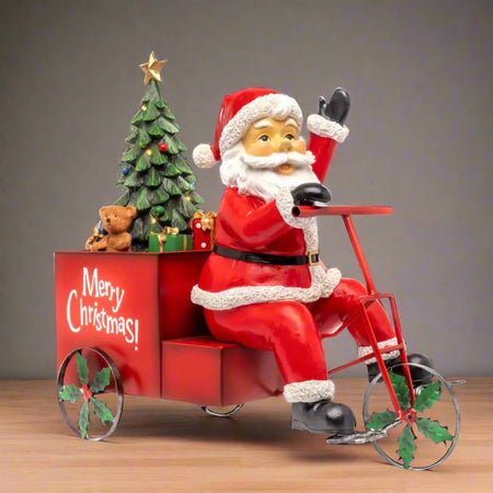 Statuetta natalizia decorativa Babbo Natale con triciclo con lei in resina da 53 cm