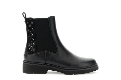 TRONCHETTO IN SINTETICO EFFETTO PELLE CON ELASTICO E INSERTI DI STRASS E BORCHIE