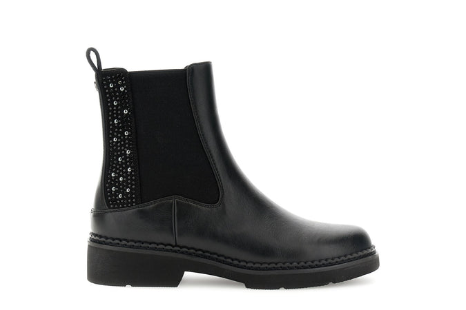 TRONCHETTO IN SINTETICO EFFETTO PELLE CON ELASTICO E INSERTI DI STRASS E BORCHIE