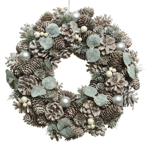Ghirlanda tonda natalizia con pigne innevate e sfere bianche dietro porta 34 cm