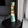 FISURA Lampada lava con base in giada, con liquido trasparente e lava color menta
