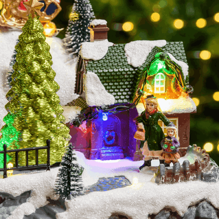 Paesaggio natalizio con Babbo Natale su slitta volante e pattinatori in movimento, led multicolor