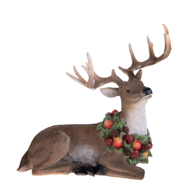 Renna in resina seduta con ghirlanda di frutta per decorazioni natalizie