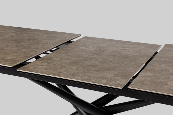 Tavolo allungabile Seyfert con struttura in acciaio, piano in ceramica e supporto in vetro