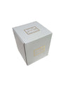 Candela in vetro ambra con forma bon bon e nappina decorativa, firmata Special Gifts, altezza 11 cm, diametro 8 cm, con scatola regalo.