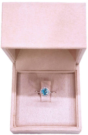 Anello in oro bianco 18 Kt con Topazio azzurro centrale coronato da tormaline bianche