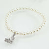 Bracciale donna elastico in perle sintetiche con pavoncella sarda in argento