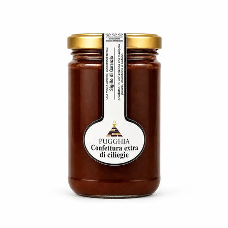 Barattolo di vetro con coperchio oro e etichetta bianca contenente confettura extra di ciliegie rosse scure 300 gr