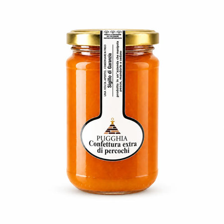 Un barattolo di vetro con confettura extra di percoche arancione vivace da 300 gr con etichetta bianca elegante e coperchio oro