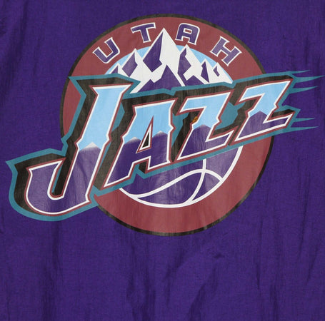 MITCHELL-&amp;-NESS-Giacca-a-Vento-Infilabile-Uomo-Nba-Highlight-Reel-Windbreaker-Hardwood-Classics-Utajaz-Original-Team-Colors-da-uomo