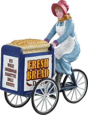 Ragazza che vende il pane fresco con un carrello blu personaggio in poliresina per villaggio di Natale Casa e cucina/Decorazioni per interni/Addobbi e decorazioni per ricorrenze/Decorazioni natalizie/Oggettistica MagiediNatale.it - Altamura, Commerciovirtuoso.it