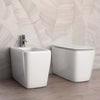 Sanitari-a-Terra-Filo-Muro-in-ceramica-bianca-con-copri-vaso-frizionato-Qubo